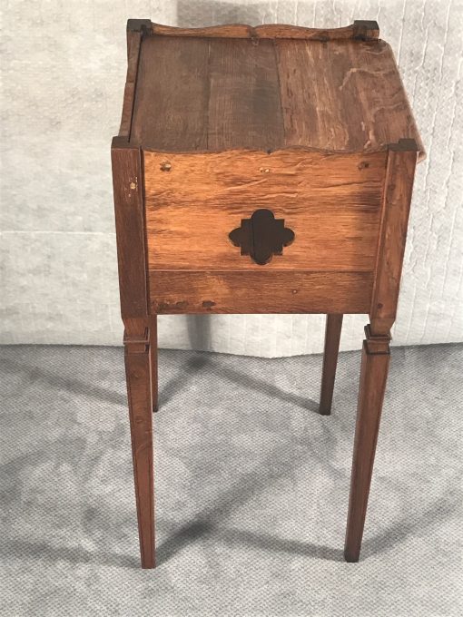 Two provincial nightstands- one of the two- side view with open work decor- styylish