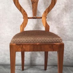 Six Biedermeier walnut chairs- one chair close up of the front- styylish