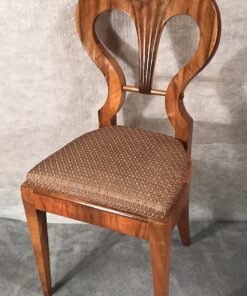 Six Biedermeier walnut chairs- one chair in three-quarter view- styylish