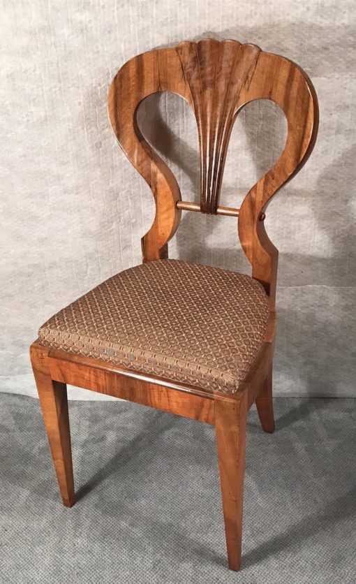 Six Biedermeier walnut chairs- one chair in three-quarter view- styylish